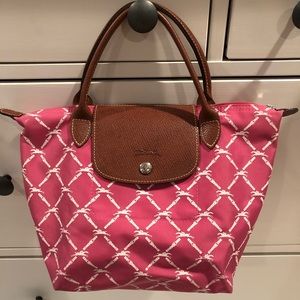 Pink mini longchamp bag.